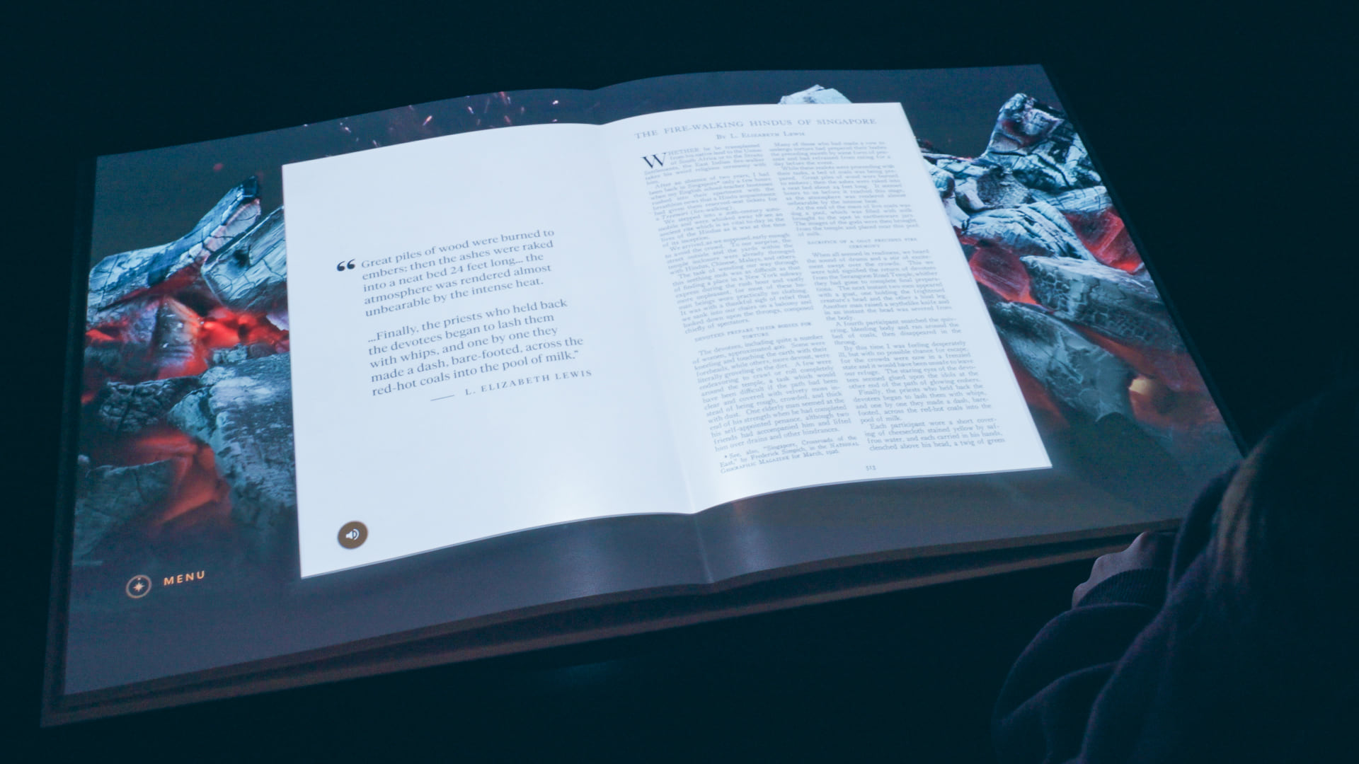 Projected magazine pages surrounded by a mountain landscape