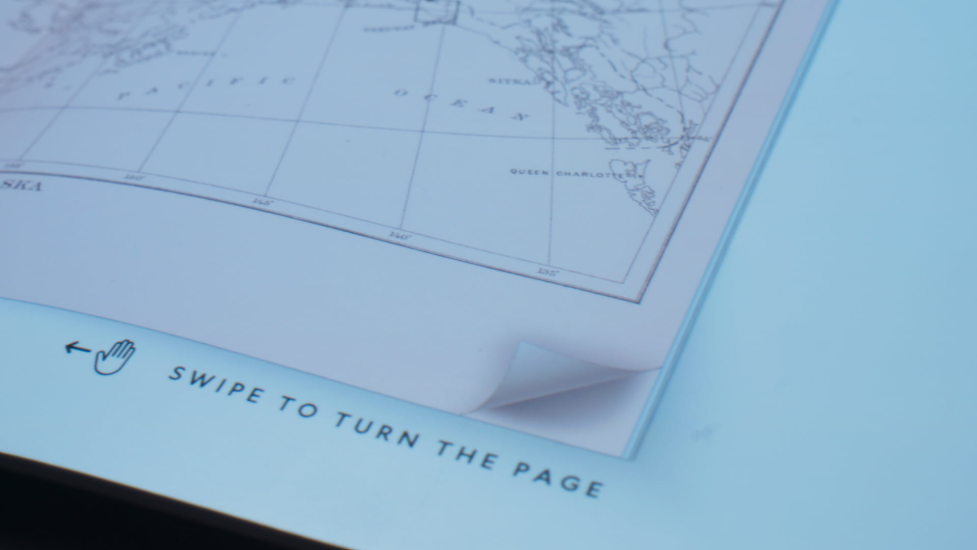 A projected hand icon and the instruction Swipe to turn the page
